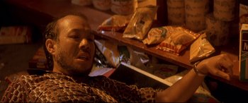 Movie still from “Falling Down” (1993), directed by Joel Schumacher – A man sitting on the floor next to a pile of food; Close Up shot, Overhead angle