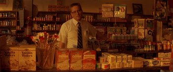Movie still from “Falling Down” (1993), directed by Joel Schumacher – A man standing in front of a counter in a grocery store; Medium shot, Low angle