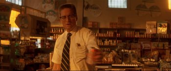 Movie still from “Falling Down” (1993), directed by Joel Schumacher – A man in white shirt and tie holding a can of soda; Medium shot, Low angle