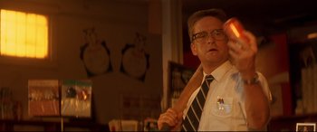 Movie still from “Falling Down” (1993), directed by Joel Schumacher – A man in a tie holding an axe in a room; Close Up shot, Low angle