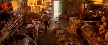 Movie still from “Falling Down” (1993), directed by Joel Schumacher – A man walking through a store filled with lots of trash; Wide shot, High angle
