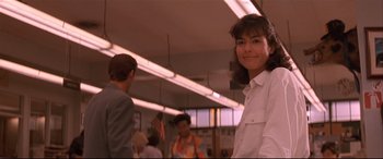 Movie still from “Falling Down” (1993), directed by Joel Schumacher – A woman standing in front of a group of people; Close Up shot, Low angle