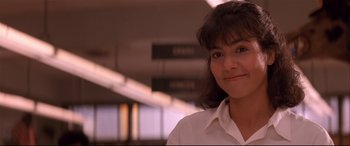 Movie still from “Falling Down” (1993), directed by Joel Schumacher – A woman in a white shirt is smiling for the camera; Close Up shot, Low angle