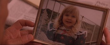 Movie still from “Falling Down” (1993), directed by Joel Schumacher – A person holding a picture of a child in a frame; Extreme Close Up shot, High angle