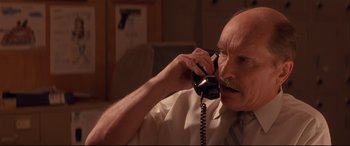 Movie still from “Falling Down” (1993), directed by Joel Schumacher – An older man talking on a phone while wearing a tie; Close Up shot, Low angle