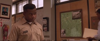 Movie still from “Falling Down” (1993), directed by Joel Schumacher – A man standing in front of a map in an office; Close Up shot, Over the shoulder angle