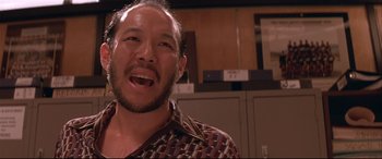 Movie still from “Falling Down” (1993), directed by Joel Schumacher – A person with long hair and a beard; Close Up shot, Low angle