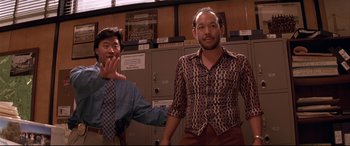 Movie still from “Falling Down” (1993), directed by Joel Schumacher – Two men standing next to each other in front of a row of lockers; Medium shot, Low angle