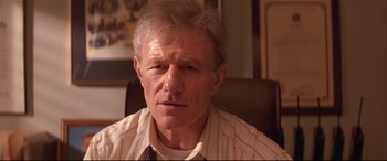 Movie still from “Falling Down” (1993), directed by Joel Schumacher – An older man wearing a shirt and a tie; Close Up shot, Low angle