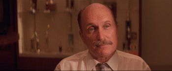 Movie still from “Falling Down” (1993), directed by Joel Schumacher – An older man with a mustache wearing a white dress shirt and a tie; Close Up shot, Low angle