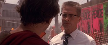 Movie still from “Falling Down” (1993), directed by Joel Schumacher – A man wearing glasses and a tie talking to another man wearing glasses; Close Up shot, Over the shoulder angle