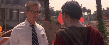 Movie still from “Falling Down” (1993), directed by Joel Schumacher – A man wearing a tie talks to another man; Close Up shot, Over the shoulder angle