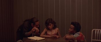 Movie still from “Falling Down” (1993), directed by Joel Schumacher – A group of people sitting at a wooden table; Medium shot, High angle