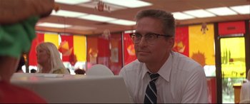 Movie still from “Falling Down” (1993), directed by Joel Schumacher – A man sitting in front of a computer in an office setting; Close Up shot, Low angle