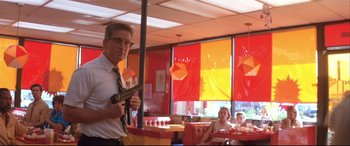 Movie still from “Falling Down” (1993), directed by Joel Schumacher – A man holding a toy gun in a restaurant; Medium shot, Low angle