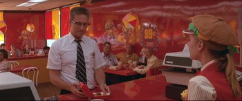 Movie still from “Falling Down” (1993), directed by Joel Schumacher – A group of people sitting at a table in a restaurant; Medium shot, Low angle