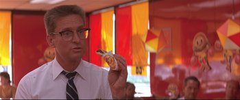 Movie still from “Falling Down” (1993), directed by Joel Schumacher – A man holding a hot dog in his hand; Close Up shot, Over the shoulder angle