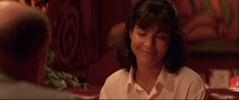 Movie still from “Falling Down” (1993), directed by Joel Schumacher – A young woman sitting in front of a red wall; Close Up shot, Low angle