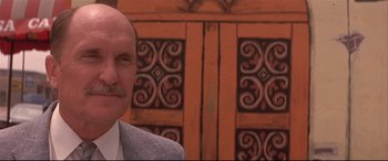 Movie still from “Falling Down” (1993), directed by Joel Schumacher – An older man in a suit and tie in front of an ornate wooden door; Close Up shot, Low angle