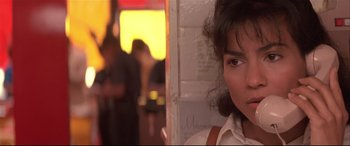 Movie still from “Falling Down” (1993), directed by Joel Schumacher – A young woman is standing in front of a window; Close Up shot, Over the shoulder angle