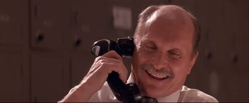 Movie still from “Falling Down” (1993), directed by Joel Schumacher – An older man talking on a phone while wearing a tie; Close Up shot, Low angle