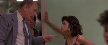 Movie still from “Falling Down” (1993), directed by Joel Schumacher – A man and a woman pointing at a woman's face; Close Up shot, Over the shoulder angle