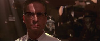 Movie still from “Falling Down” (1993), directed by Joel Schumacher – A man wearing glasses and a white dress shirt; Close Up shot, Low angle