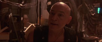 Movie still from “Falling Down” (1993), directed by Joel Schumacher – A man with bald head looking into the distance; Close Up shot, Low angle