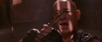 Movie still from “Falling Down” (1993), directed by Joel Schumacher – A bald man holding a knife in his hand; Close Up shot, Low angle