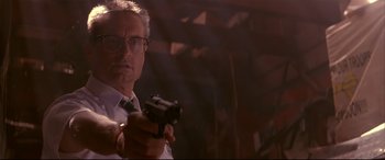 Movie still from “Falling Down” (1993), directed by Joel Schumacher – A man holding a gun while standing in a room; Close Up shot, Low angle