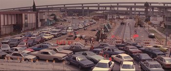 Movie still from “Falling Down” (1993), directed by Joel Schumacher – Cars are lined up in a parking lot for construction work; Extreme Wide shot, High angle