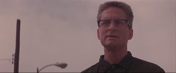 Movie still from “Falling Down” (1993), directed by Joel Schumacher – A person wearing glasses and a black shirt; Close Up shot, Low angle