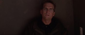 Movie still from “Falling Down” (1993), directed by Joel Schumacher – A person wearing glasses and a black jacket; Close Up shot, Low angle