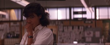 Movie still from “Falling Down” (1993), directed by Joel Schumacher – A woman in a white shirt is looking to her left; Close Up shot, Over the shoulder angle