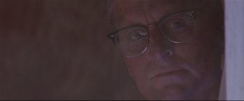 Movie still from “Falling Down” (1993), directed by Joel Schumacher – A person wearing glasses; Close Up shot, Low angle