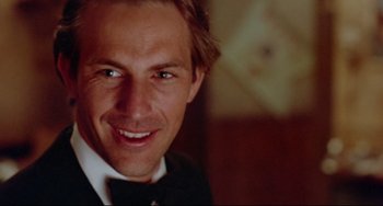 Movie still from “Fandango” (1985), directed by Kevin Reynolds – A person wearing a suit and bow tie; Close Up shot, Low angle