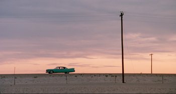 Movie still from “Fandango” (1985), directed by Kevin Reynolds – An old car parked in the middle of a field; Extreme Wide shot, Low angle