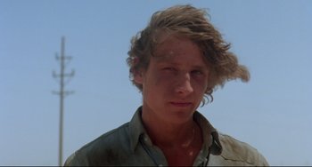 Movie still from “Fandango” (1985), directed by Kevin Reynolds – A young man with a messy hair style; Close Up shot, Low angle