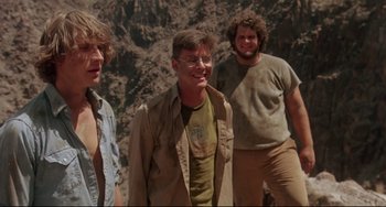 Movie still from “Fandango” (1985), directed by Kevin Reynolds – A group of men standing next to each other; Medium shot, Low angle