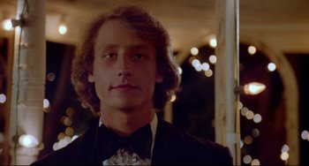 Movie still from “Fandango” (1985), directed by Kevin Reynolds – A young man in a suit and a bow tie; Close Up shot, Low angle