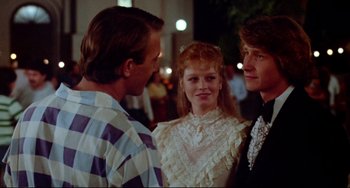 Movie still from “Fandango” (1985), directed by Kevin Reynolds – A group of people standing next to each other at a party; Close Up shot, Over the shoulder angle