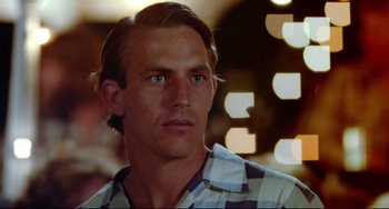 Movie still from “Fandango” (1985), directed by Kevin Reynolds – A person wearing a checkered shirt; Close Up shot, Low angle