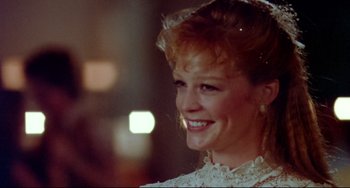 Movie still from “Fandango” (1985), directed by Kevin Reynolds – A person wearing a white dress; Close Up shot, Over the shoulder angle