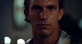 Movie still from “Fandango” (1985), directed by Kevin Reynolds – A man's face in the dark; Close Up shot, Low angle