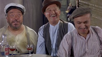 Movie still from “Fanny” (1961), directed by Joshua Logan – A group of men sitting at a table with a glass of red wine; Medium shot, High angle