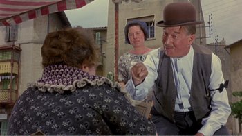 An older man and woman are talking to each other