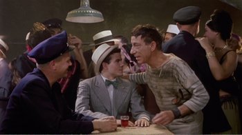 Movie still from “Fanny” (1961), directed by Joshua Logan – A group of men sitting at a table with hats on their heads; Medium shot, High angle