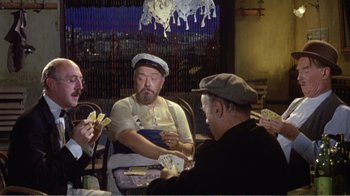Movie still from “Fanny” (1961), directed by Joshua Logan – A group of people sitting at a table playing cards; Medium shot, High angle
