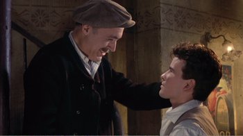 Movie still from “Fanny” (1961), directed by Joshua Logan – A man and a young boy are smiling at each other; Medium shot, Low angle