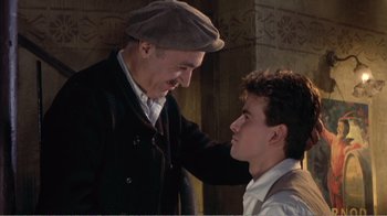 Movie still from “Fanny” (1961), directed by Joshua Logan – A man and a young man standing next to each other; Medium shot, Over the shoulder angle